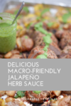A jar of Jalapeño Herb Sauce with a spoon sits next to roasted meat and potatoes. White text overlay reads Delicious Macro-Friendly Jalapeño Herb Sauce. Website URL appears at the bottom.
