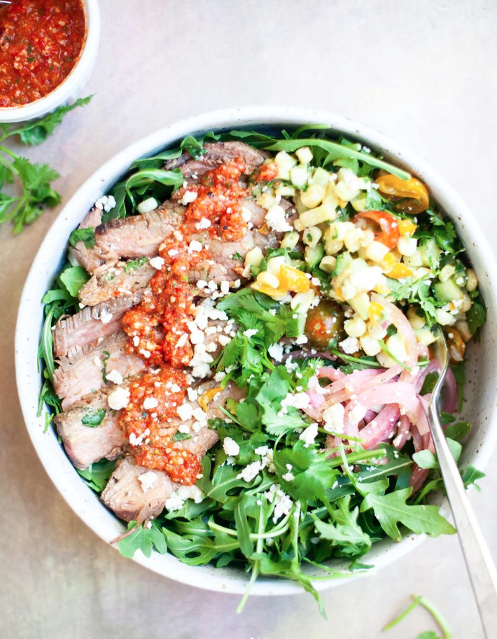 The marinade for this sweet garlic spiced grilled flank steak comes together so fast! www.lillieeatsandtells.com