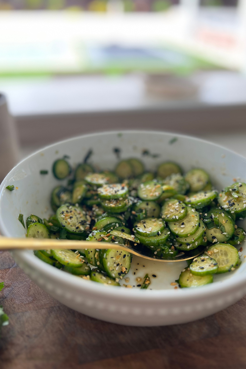 Sesame cucumber salad with a large bowl.