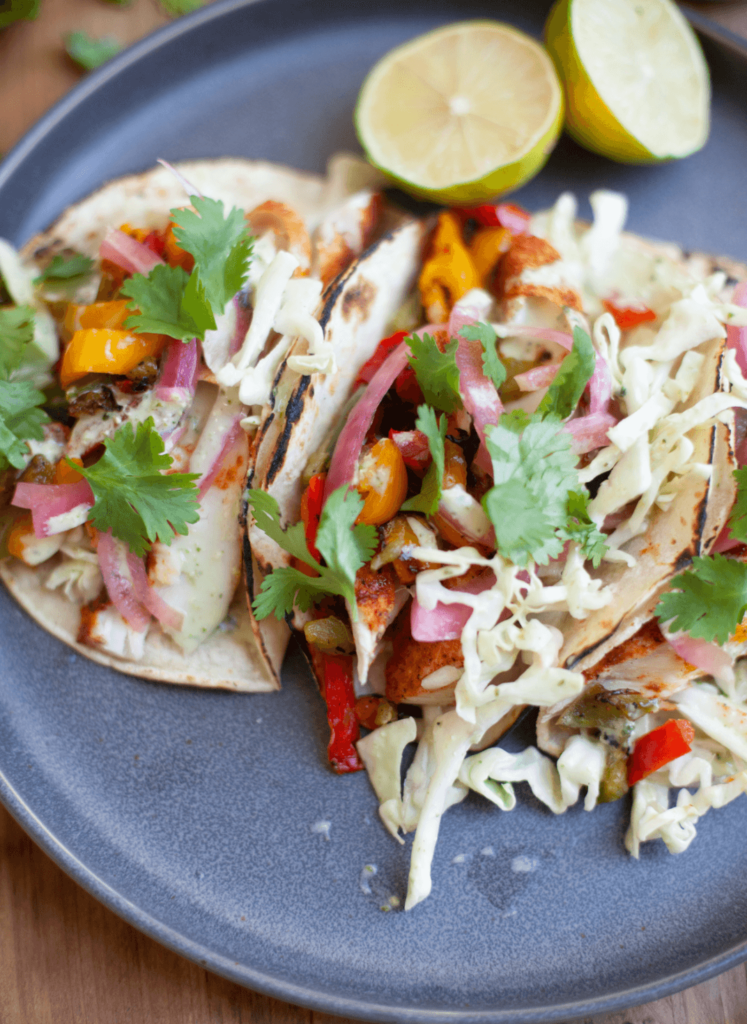 Fish tacos with all the topping on a plate