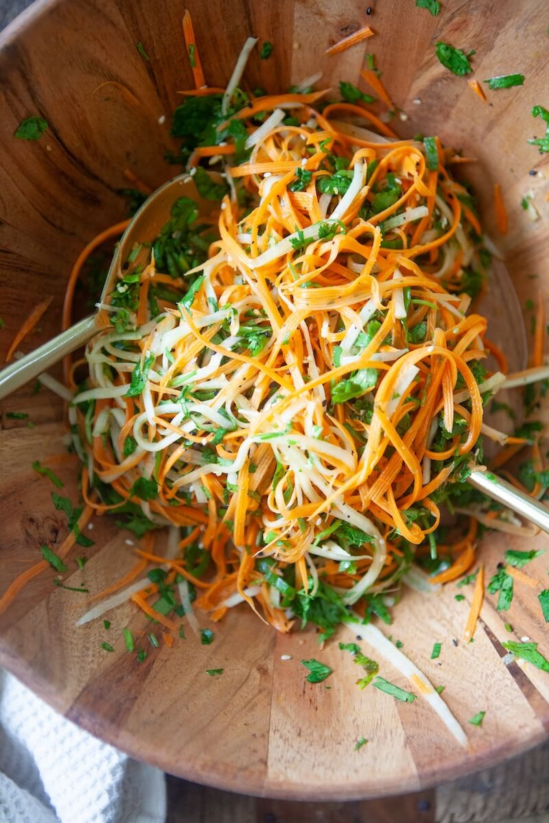 Sliced carrots and jicima in a bowl.