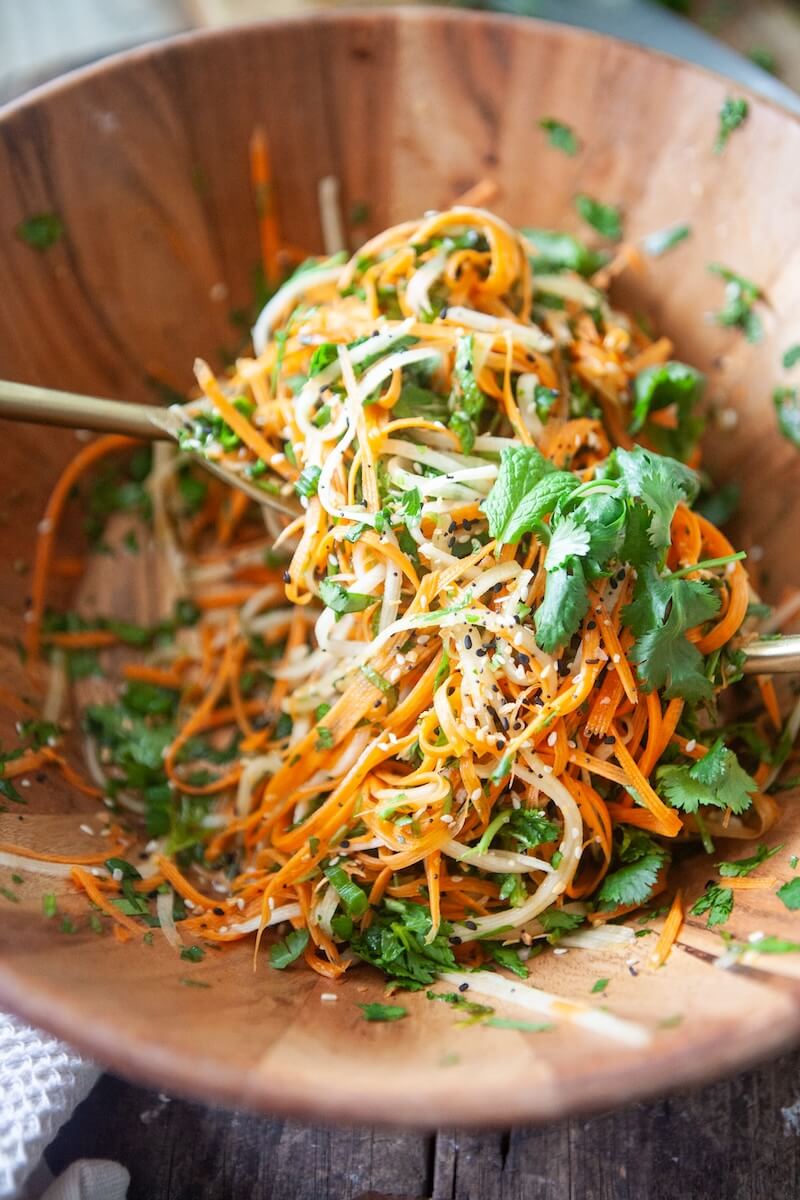 Ingredients for carrot coleslaw in a mixing bowl.
