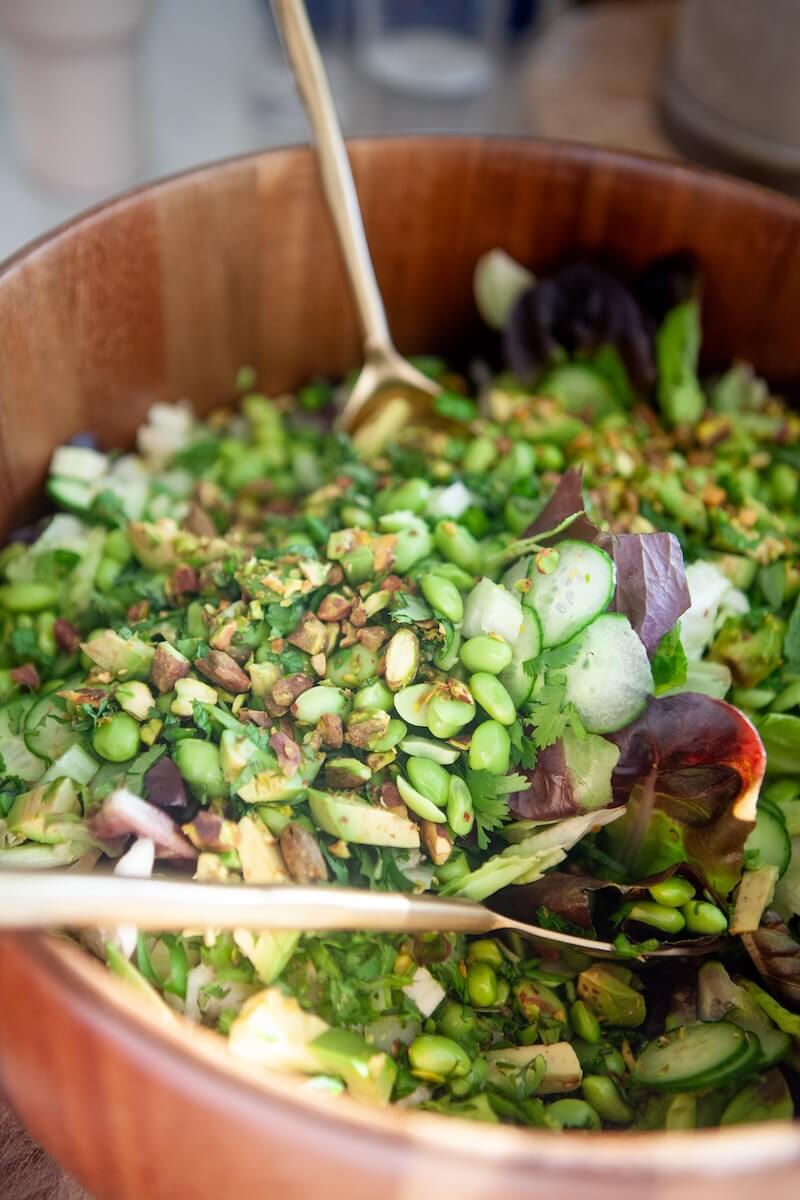 Ingredients for super green salad in a large mixing bowl.