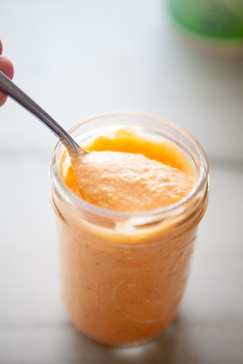 Delicious feta spread on a metal spoon.