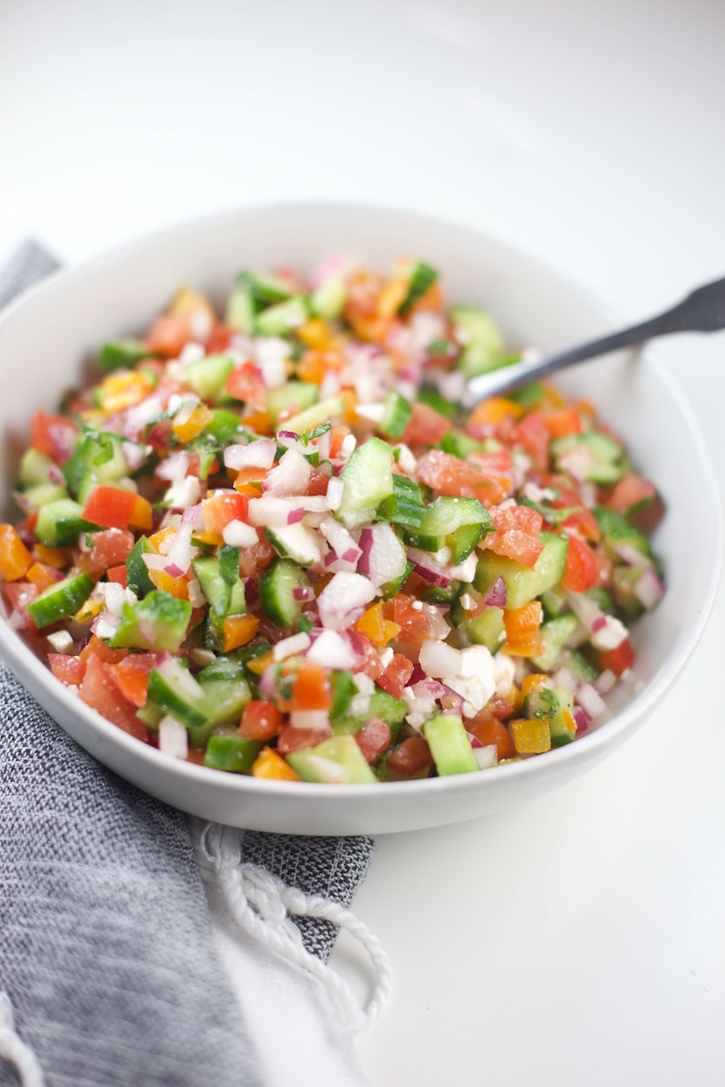 Large white bowl full of Greek cucumber salsa.
