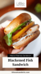 Close up of someone holding a fish sandwich