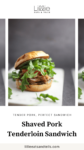 Shaved pork tenderloin sandwich with arugula on a white plate.