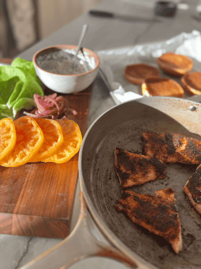 Ingredients for a blackened fish sandwich on a table.