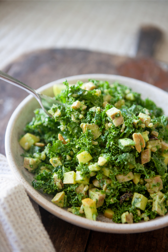 Wild rice and kale salad in bowl with fork.