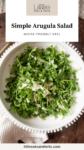 Bowl of salad with parmesan cheese with text overlay, "Simple Arugula Salad."