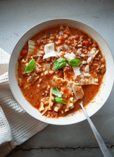 Bowl of no noodle lasagna soup with white napkin.
