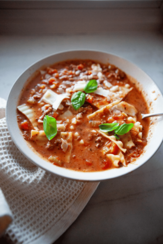 Easy lasagna soup in a white bowl with a spoon.