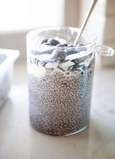 Blueberry chia pudding in glass jar with spoon.