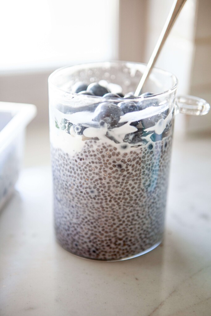 Blueberry chia pudding in glass jar with spoon.