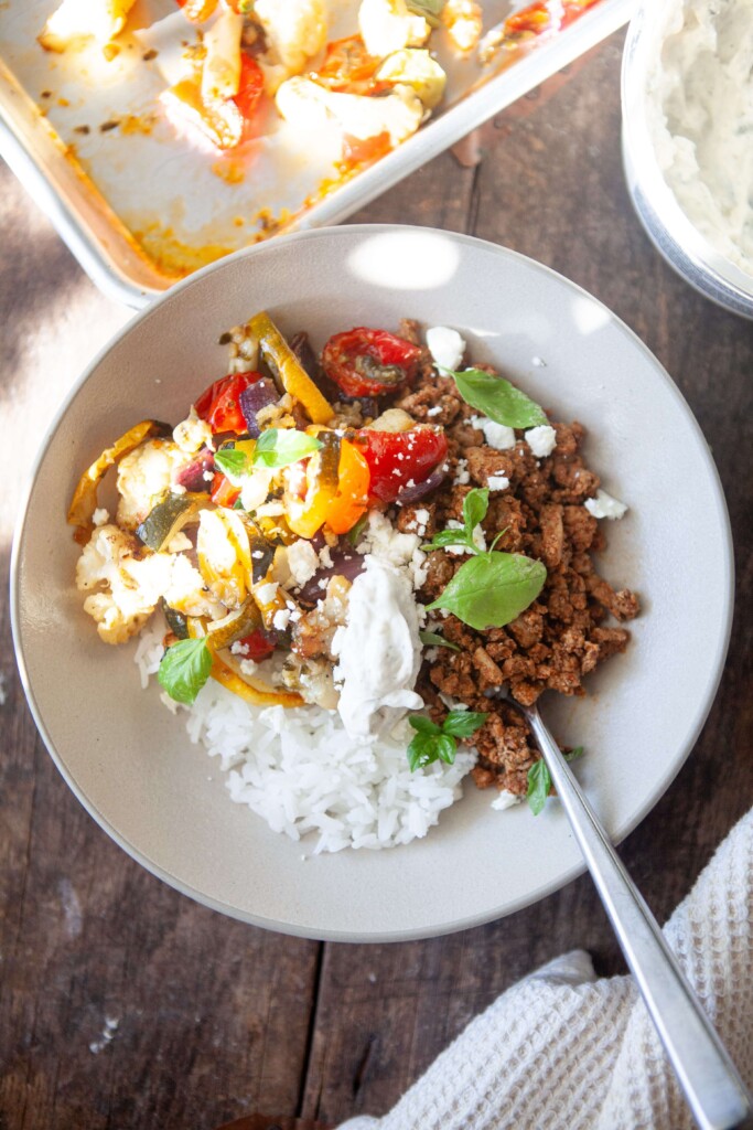 Veggie rice bowl in white bowl with fork.