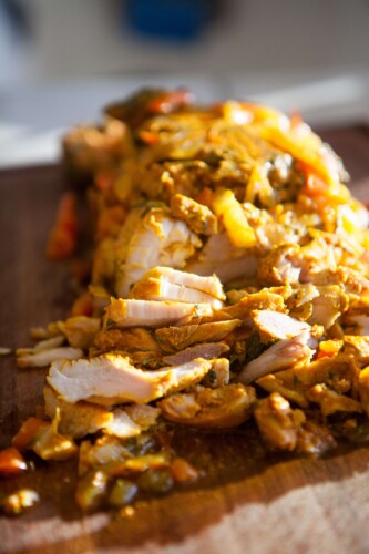 loaf pan chicken shawarma cut up on cutting board.