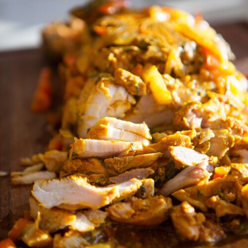 loaf pan chicken shawarma cut up on cutting board.