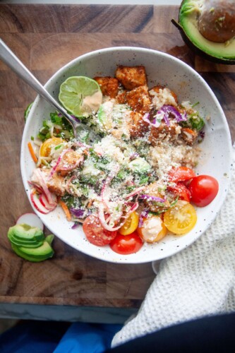 Fish taco bowl sprinkled with cotija cheese.