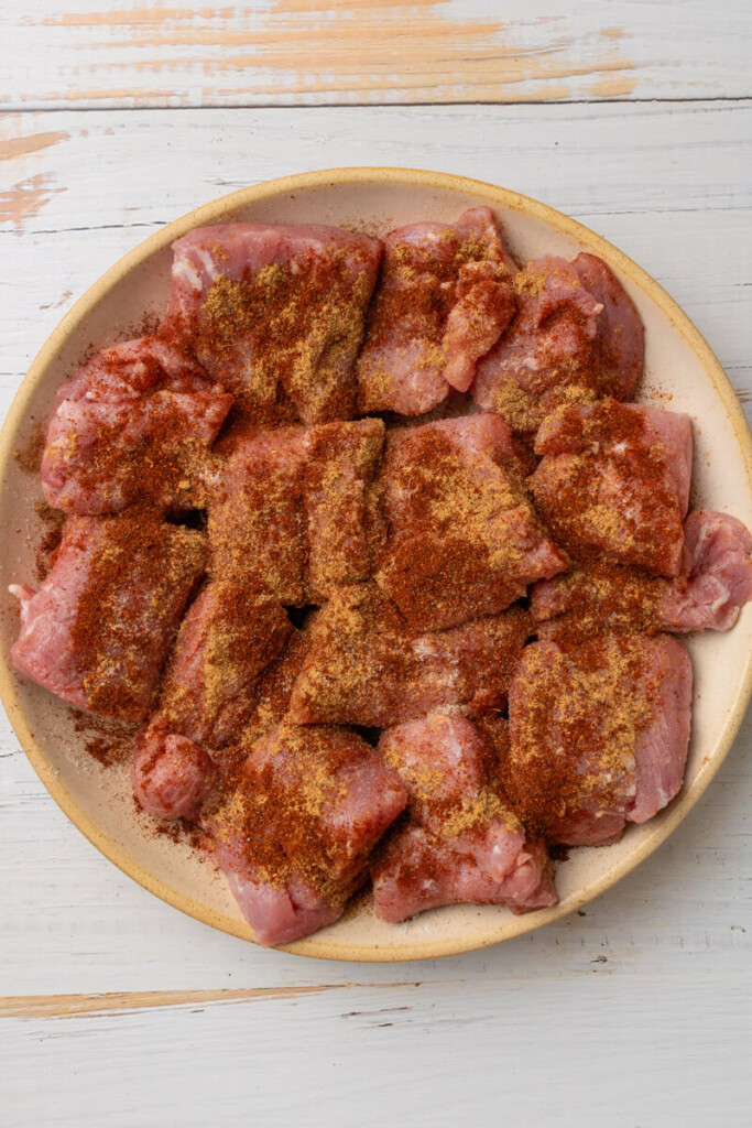 Pork tenderloin coated in seasonings before adding to instant pot.