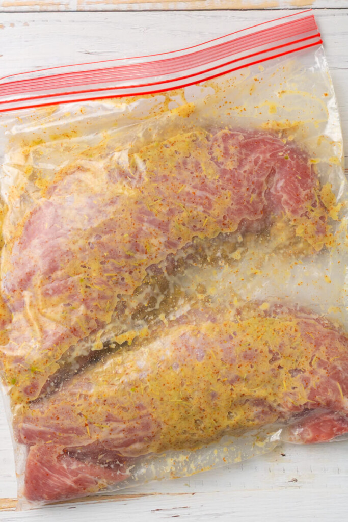 Pork tenderloin marinating in ziplock bag.