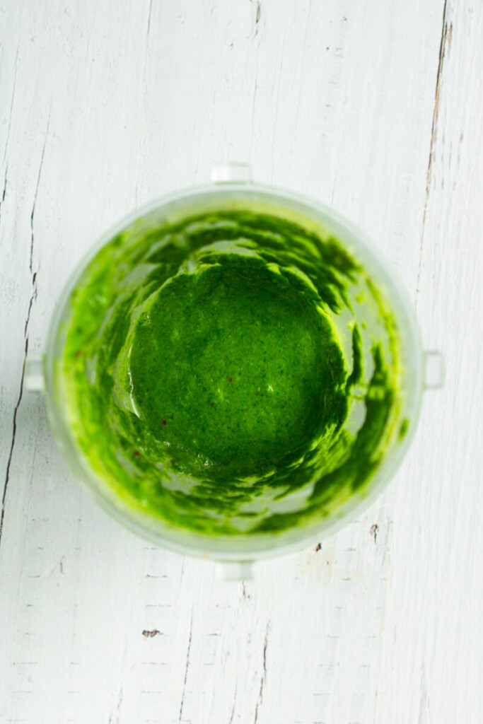 Ingredients blended together for chimichurri in small blender cup.