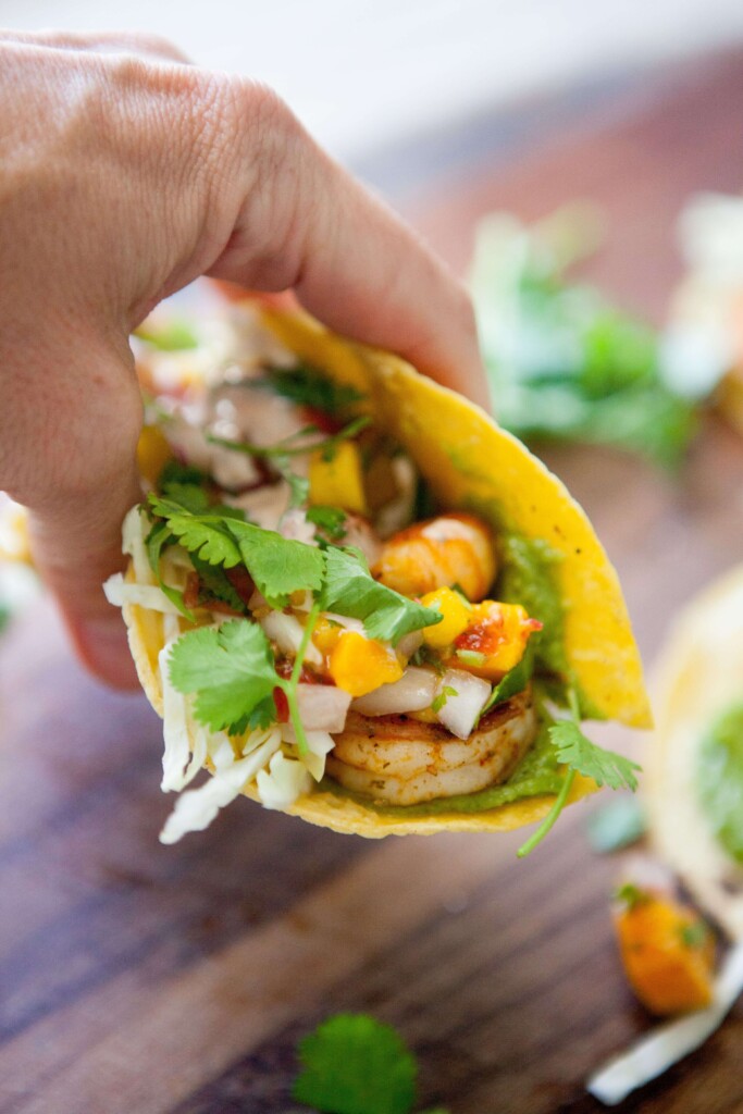 Hand holding a shrimp taco.