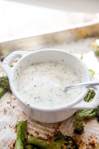 Buttermilk chive dip in small bowl with spoon.