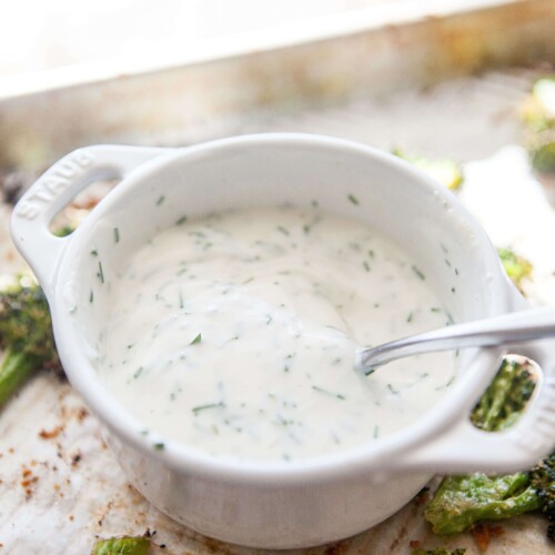 Buttermilk chive dip in small bowl with spoon.