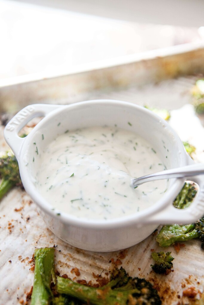 Buttermilk chive dip in small bowl with spoon.