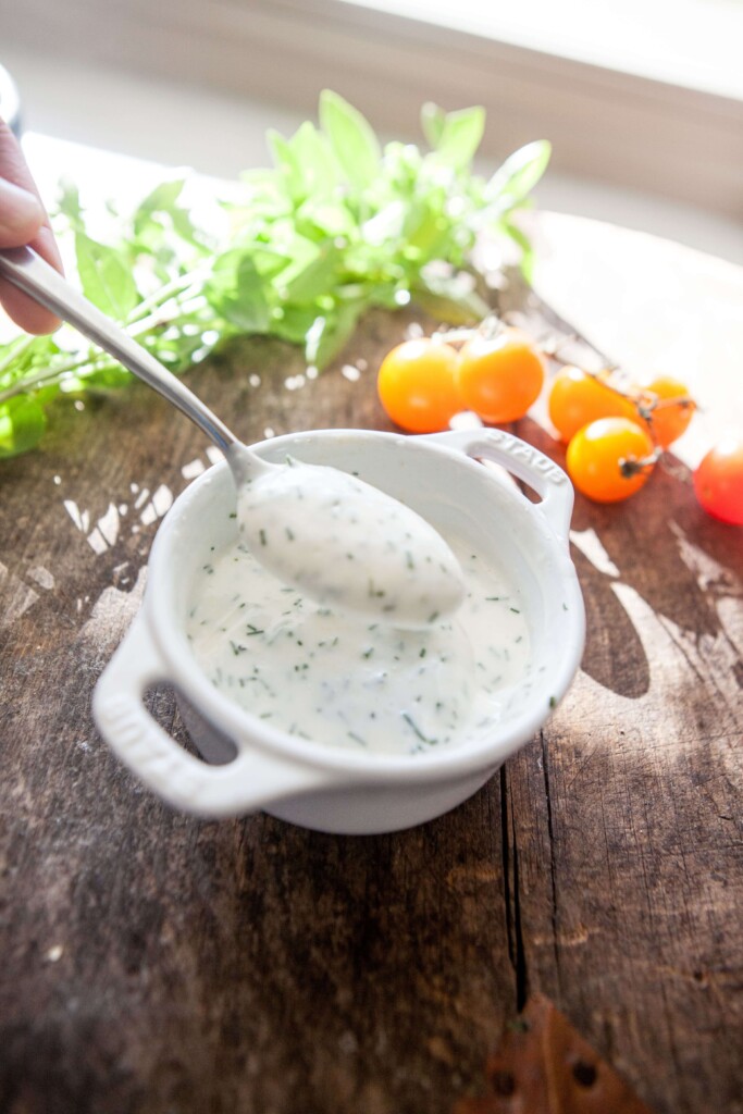 Buttermilk chive dip on spoon.