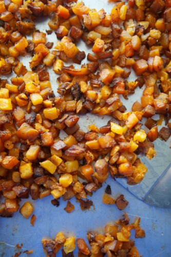 Butternut squash roasted on pan with spatula.