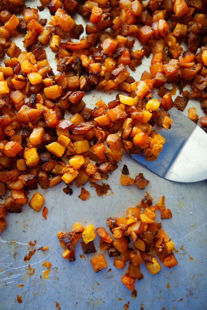 Simple roasted butternut squash cut into cubes and roasted on pan with spatula.