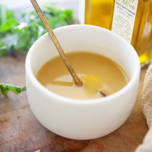 Sweet mustard vinaigrette in a small bowl with gold spoon.