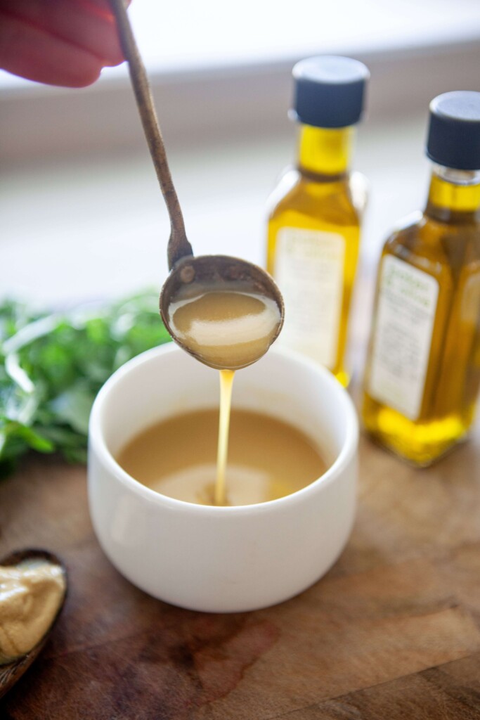 Sweet mustard vinaigrette on a spoon.