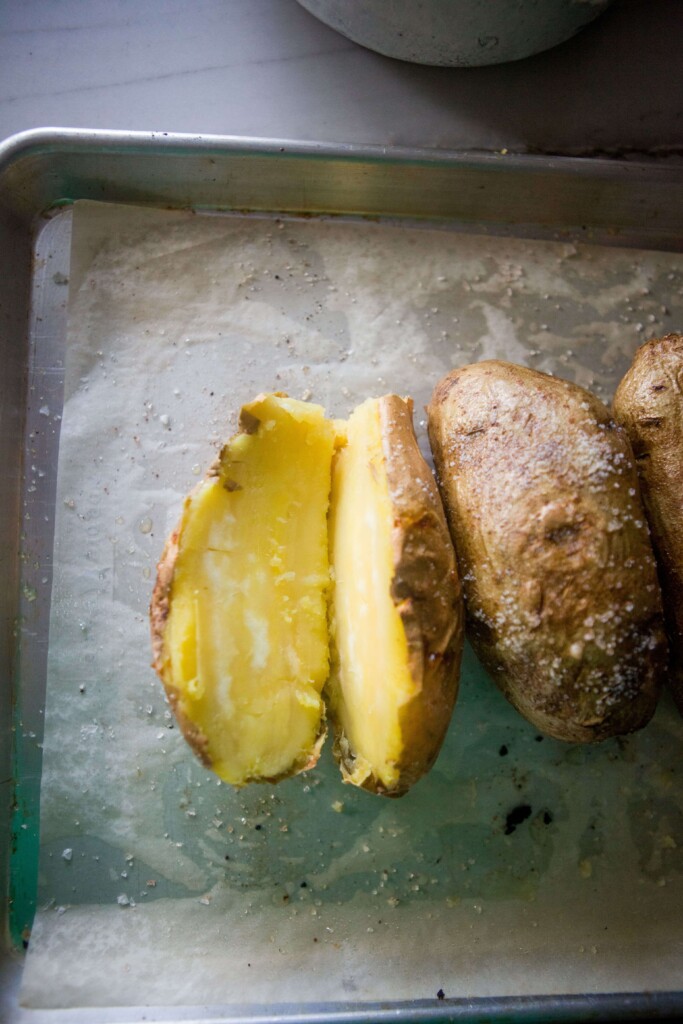 White sweet potato cut in half and baked on baking sheet.