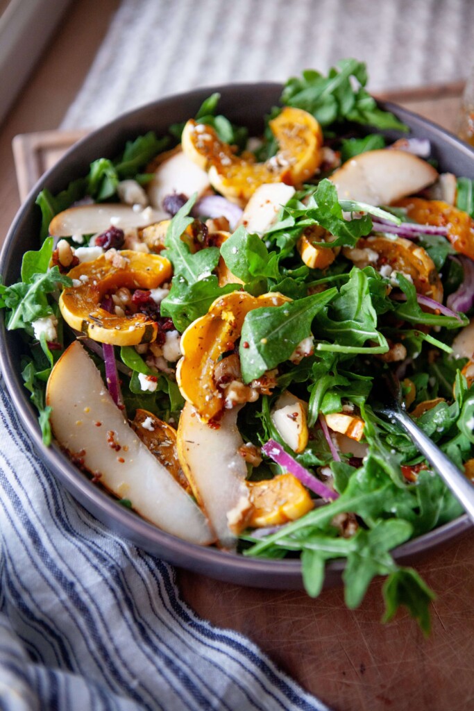 Delicata salad mixed together in bowl with fork.