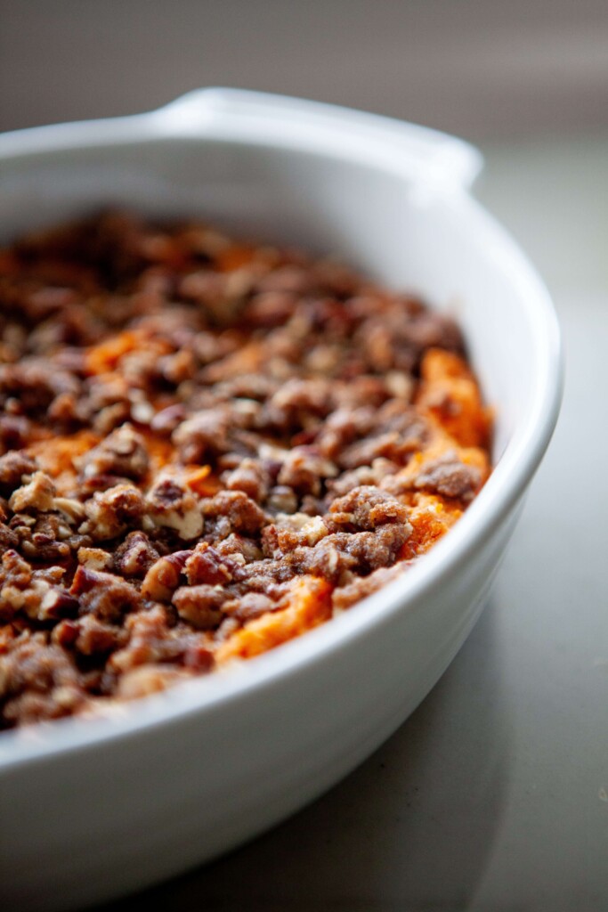 Sweet potato casserole in white baking dish.