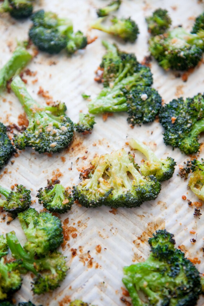 Upclose of parmesan smashed broccoli floret on sheet pan.