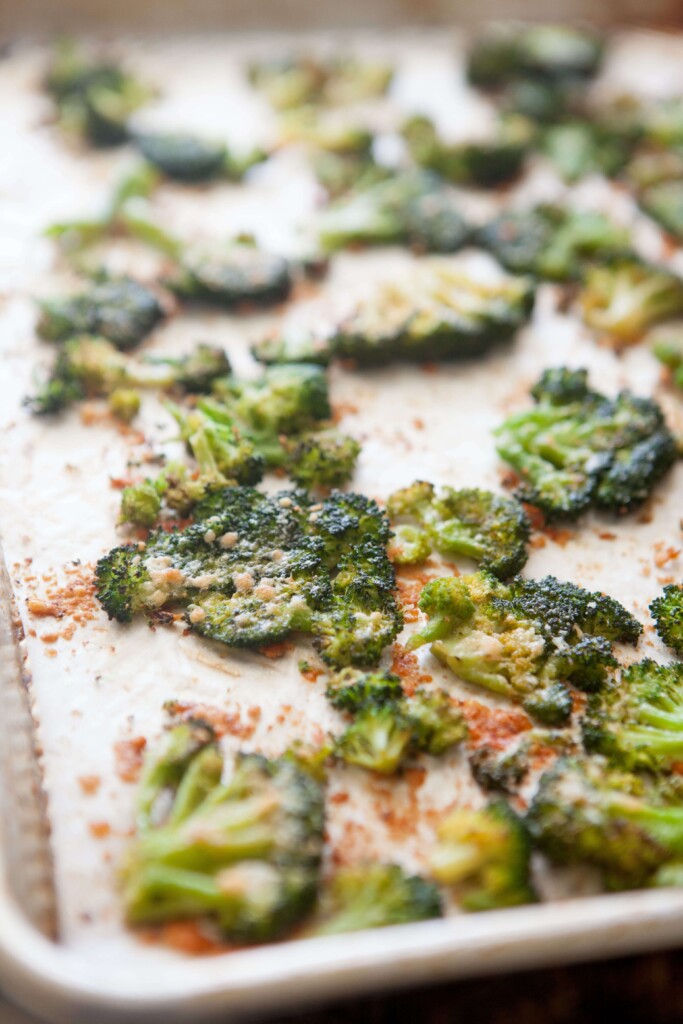 Parmesan smashed broccoli cooked on large sheet pan.