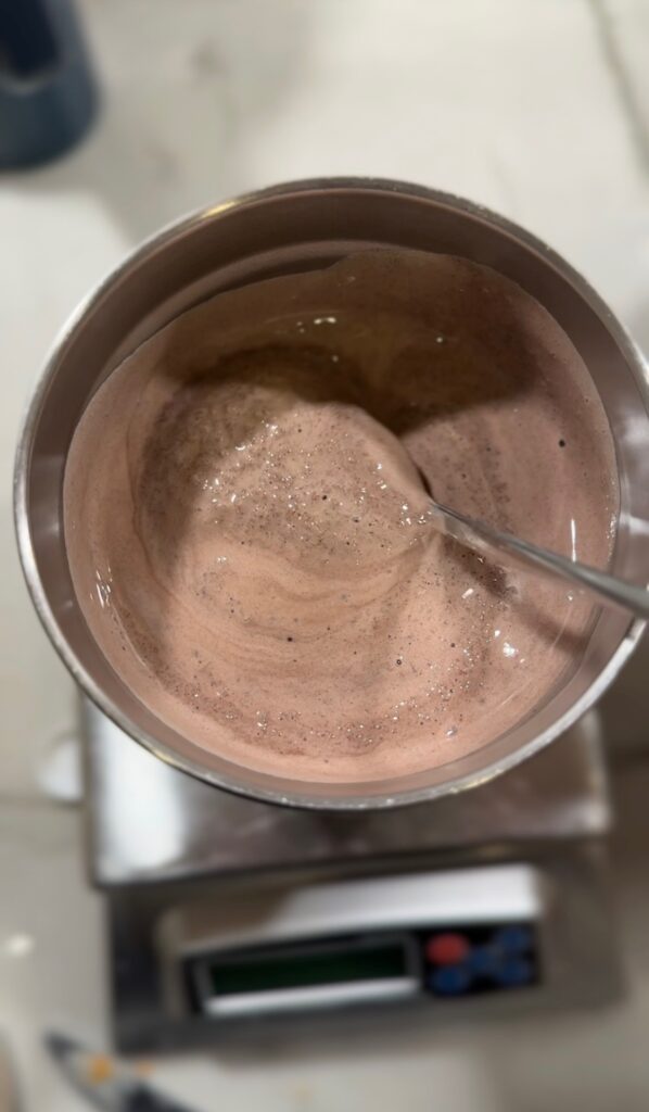 Chocolate peppermint shake in large tumbler with spoon.