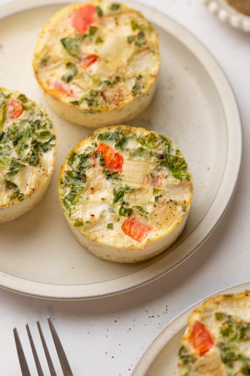 Three egg white cups on plate.