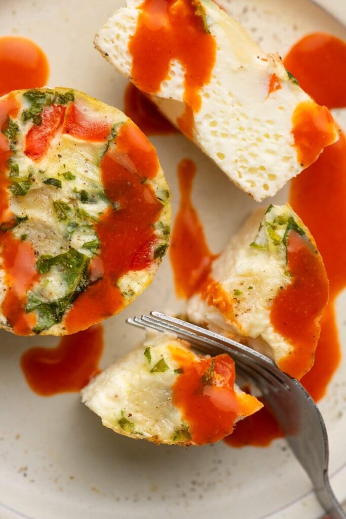 Egg white cup drizzled with hot sauce.