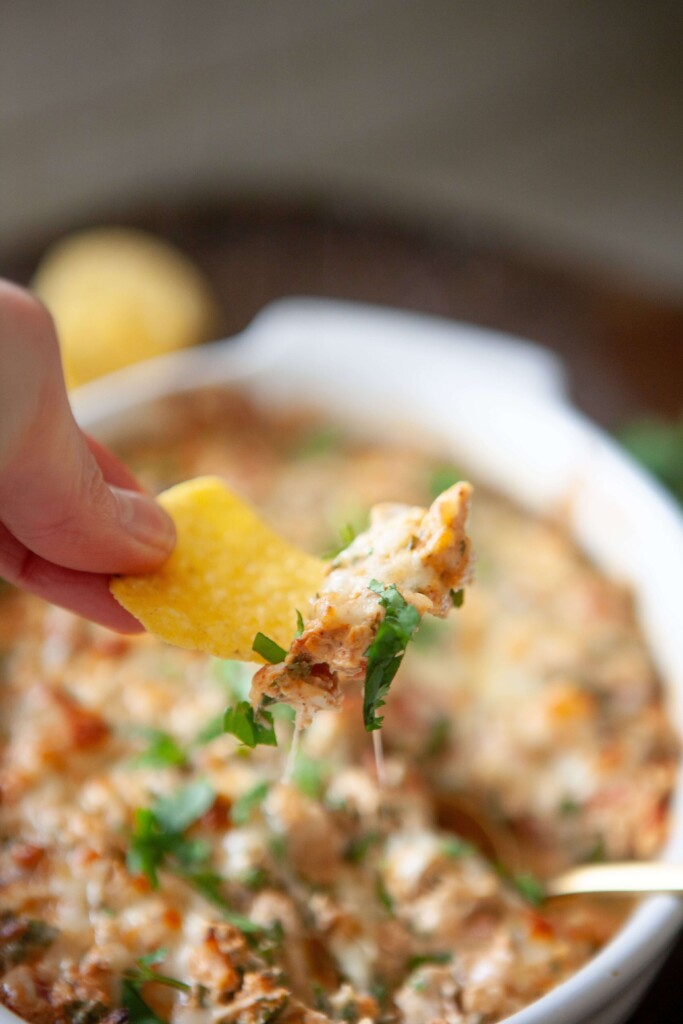 Chip scooping up rotel chicken bake.