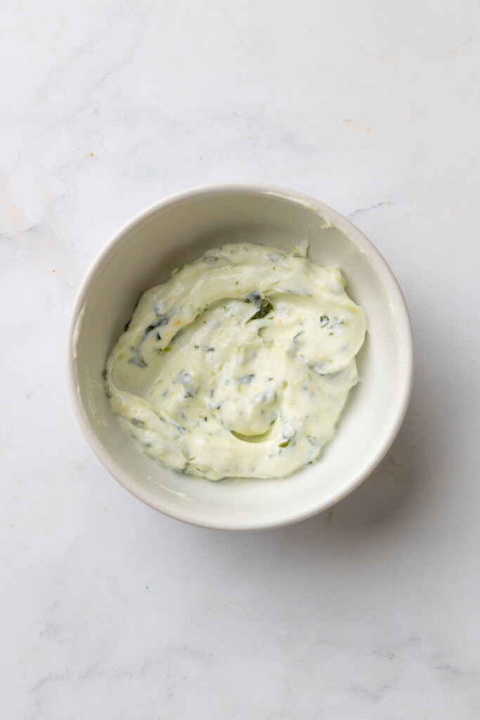 Basil yogurt mixed together in a small bowl.