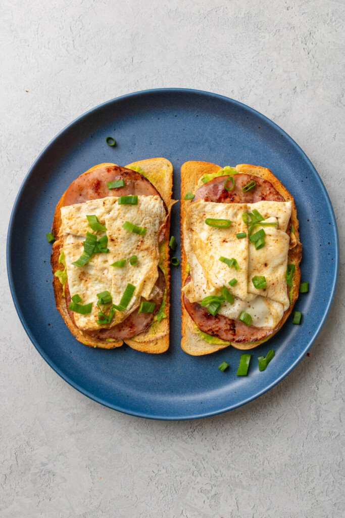 Two chipotle egg white toasts on a blue plate.
