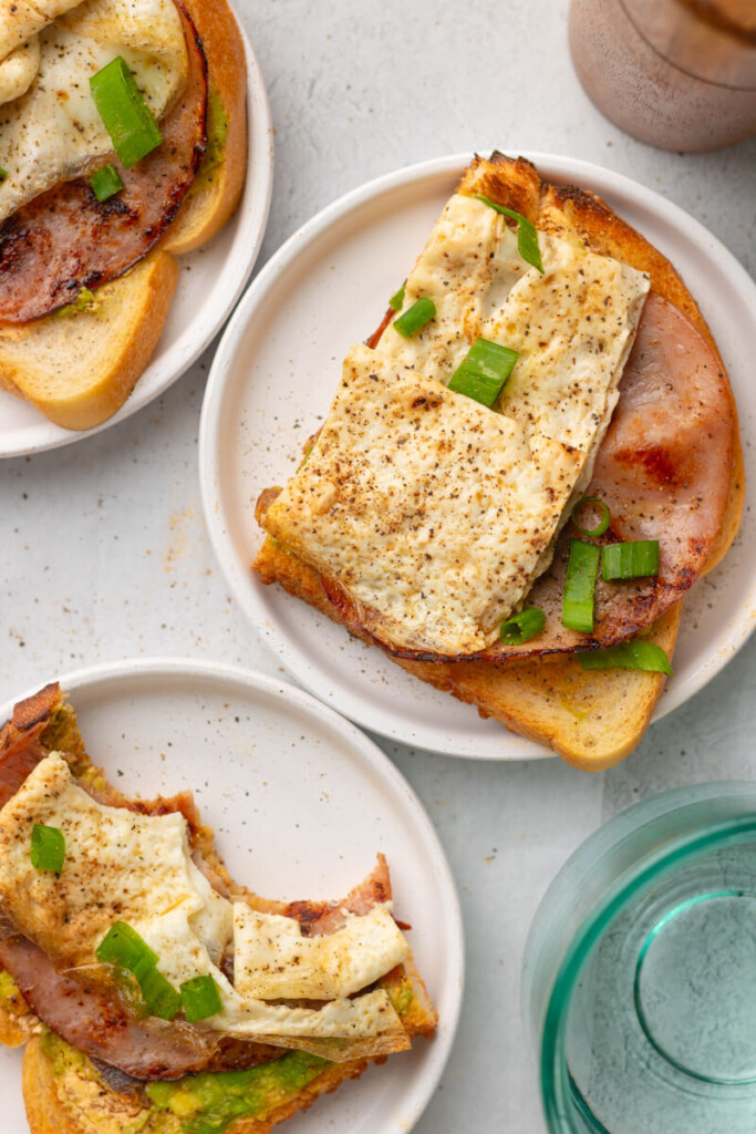 Chipotle egg white toasts on a plate topped with green onions.