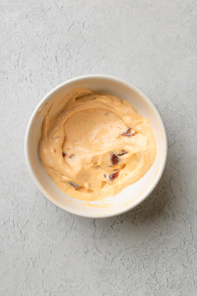 Chipotle cream mixed together in a small white bowl.