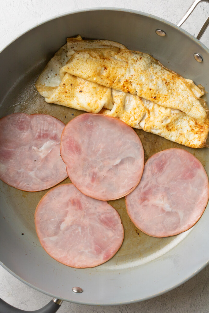 Egg white and deli ham in a skillet.
