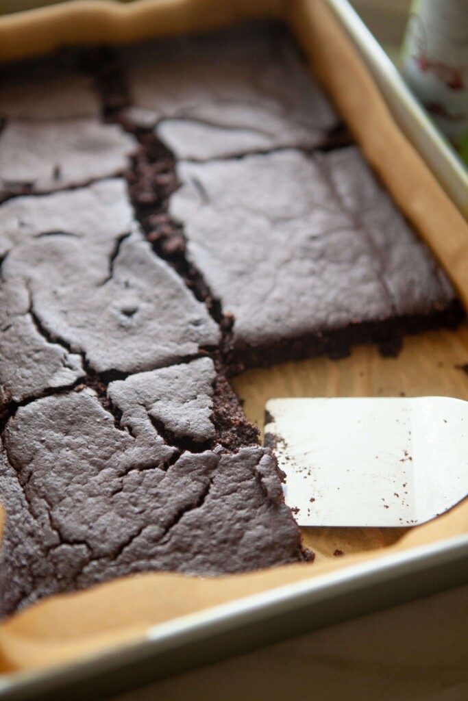 Chocolate protein breakfast bars cut into squares in baking dish.