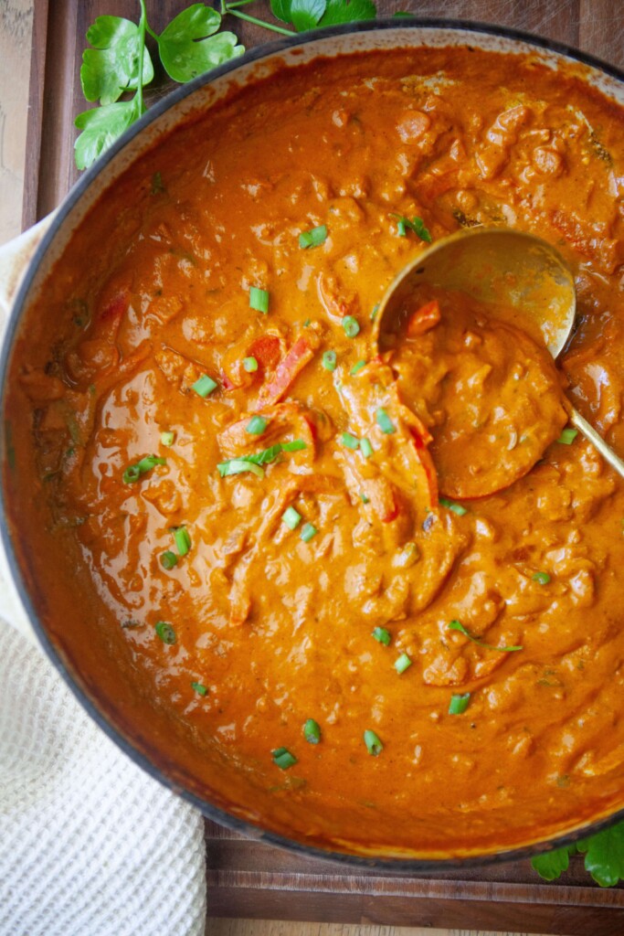 Coconut curry with peppers cooked in a pan.